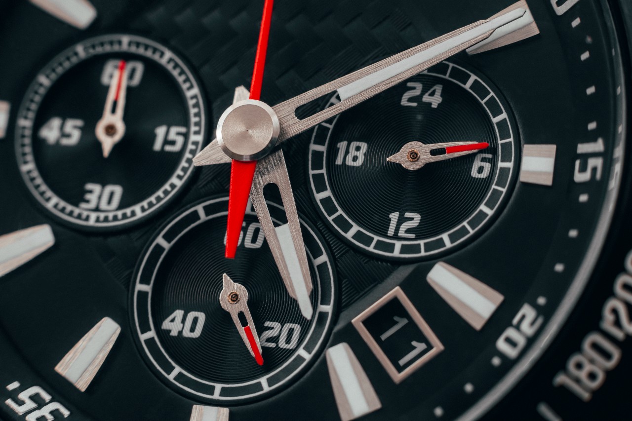 A close up of a sporty watch face with multiple complications.